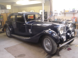 Alvis 1936 Restoration - Mudguards and running board strips, now firmly fixed. Bonnet and door catches and front lights fitted